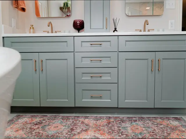 Front view of blue-green double-vanity cabinetry above a colorful patterned runner.